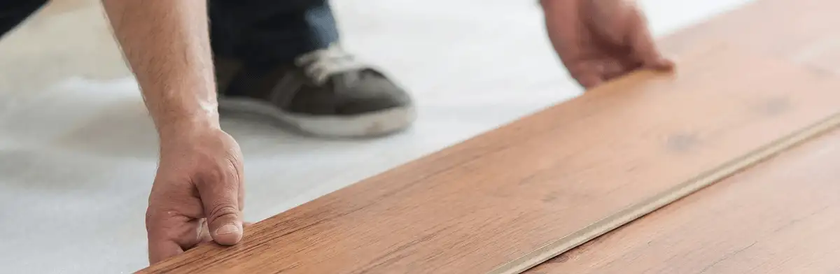 A professional installing laminate flooring in Dover, DE